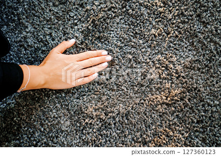 a woman's hand touching the grey Interior pile carpet a woman's hand touching the grey Interior pile carpet 127360123