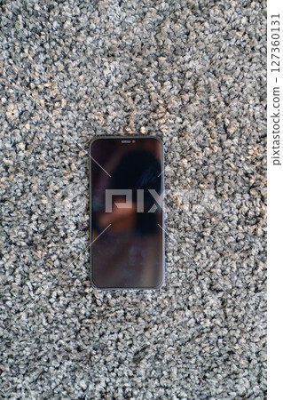 phone on the grey Interior pile carpet 127360131