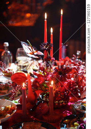 three burning candles on the banquet table in the dark.  127360159