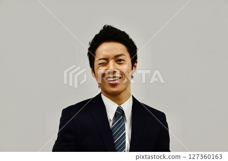 Young man winking Young man winking 127360163