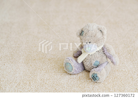 close-up. teddy bear on the beige Interior pile carpet made of polypropylene.  127360172