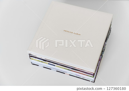 Wedding Album in gold letters on leather cover of book on books with photo cover Wedding Album in gold letters on leather cover of book on books with photo cover 127360180