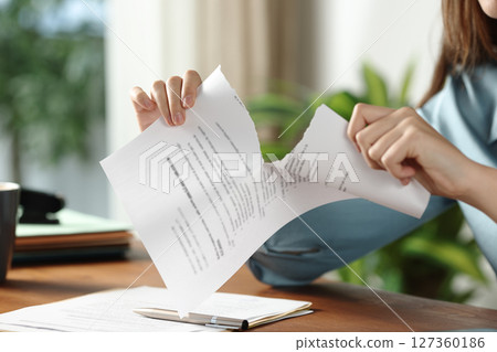 Businesswoman hands breaking contract at office 127360186