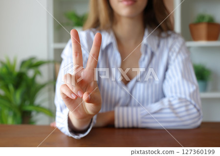 Woman hand at home gesturing number two Woman hand at home gesturing number two 127360199