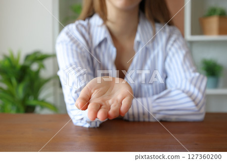 Woman hand gesturing begging at camera Woman hand gesturing begging at camera 127360200