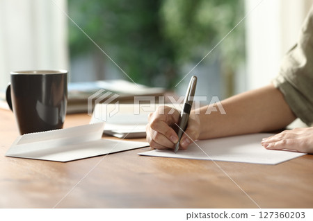 Woman hands handwriting letter on paper at home 127360203