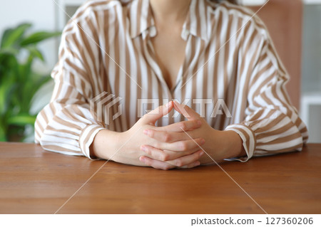 Woman hands waiting and listening in a house Woman hands waiting and listening in a house 127360206