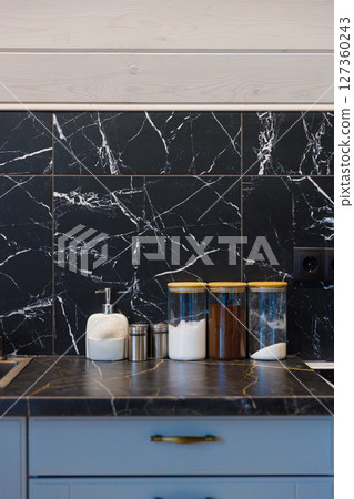 Elegant Kitchen Design Featuring Black and White Marble Backsplash with Stylish Containers and Modern Accessories for Functional and Aesthetic Appeal Elegant Kitchen Design Featuring Black and White Marble Backsplash with Stylish Containers and Modern Accessories for Functional and Aesthetic Appeal 127360243