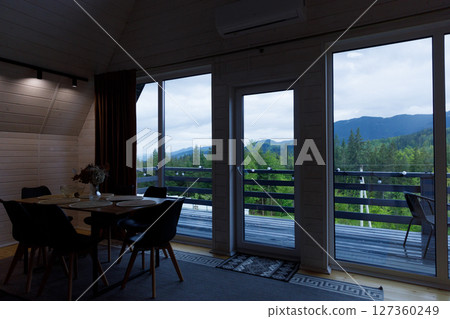 Cozy Wooden Interior Design with Scenic Mountain View and Modern Dining Area Perfect for Relaxation and Gatherings Amidst Nature's Beauty 127360249