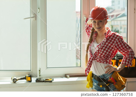 Woman with helmet next to the window 127360758