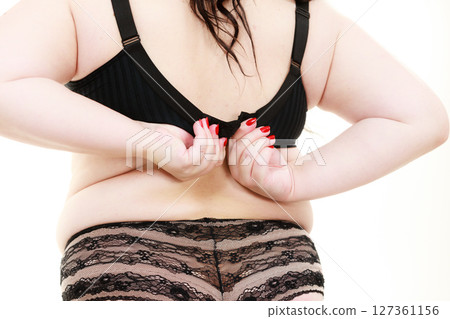 Fat woman in lingerie back view. Fat woman in lingerie back view. 127361156
