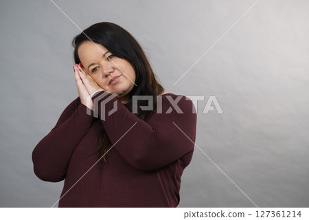 Woman being sleepy gesturing 127361214