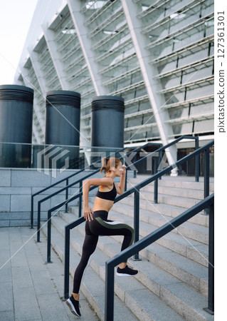 Slim woman doing exercises outdoors in the morning. Active life, sports training, healthy lifestyle. Slim woman doing exercises outdoors in the morning. Active life, sports training, healthy lifestyle. 127361301