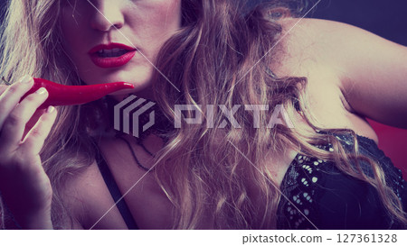 Woman wearing sexy black lingerie underwear holding pepper 127361328