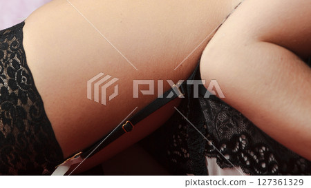 Closeup of woman thigh wearing sexy underwear 127361329