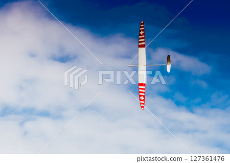 RC soaring plane on blue sky 127361476