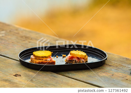 pieces of bread outdoor on wooden table 127361492