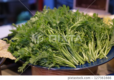harvesting fresh green herbs in an organic garden. Sustainable farming, homegrown vegetables, eco-friendly lifestyle and healthy food concept. harvesting fresh green herbs in an organic garden. Sustainable farming, homegrown vegetables, eco-friendly lifestyle and healthy food concept. 127361666