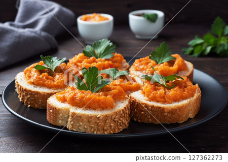 Sandwiches with bread zucchini caviar tomatoes onions. Homemade vegetarian food. Canned stewed vegetable. wooden background close up 127362273