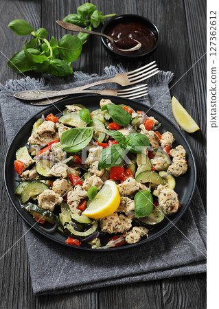 baked italian chicken and vegetables on a plate baked italian chicken and vegetables on a plate 127362612