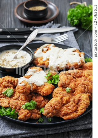 Deep fried Southern chicken thighs with milk gravy Deep fried Southern chicken thighs with milk gravy 127362613