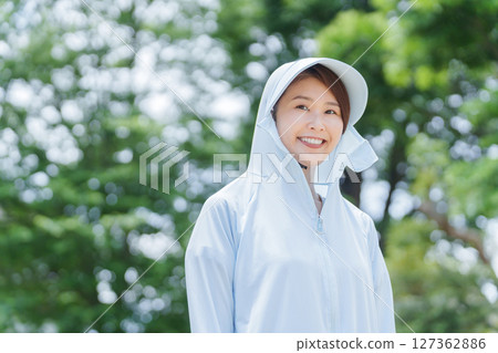 A woman wearing a rash guard to protect herself from UV rays A woman wearing a rash guard to protect herself from UV rays 127362886