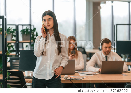 Business people in formal clothes are working in the office together 127362902