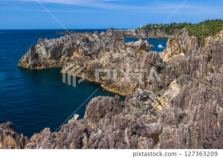 [Niigata Prefecture_Senkaku Bay] Rough cliffs created by erosion by rough waves over tens of thousands of years Spring 127363209