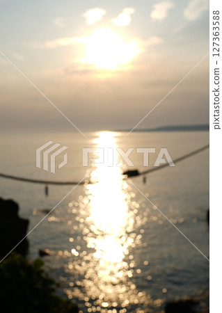 A beautiful sunset over the Meoto Iwa rocks in Noto 127363588