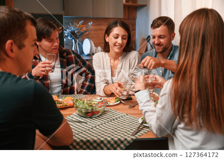 Group of people are on the kitchen, having dinner, spending time together 127364172