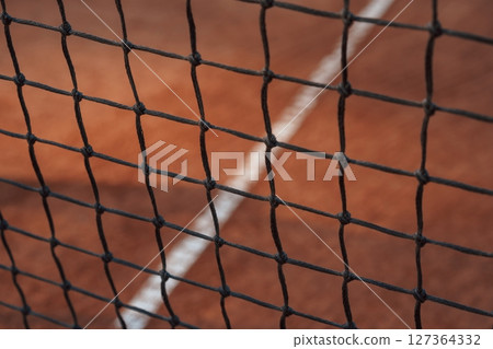 Close up view of the tennis net on the court Close up view of the tennis net on the court 127364332