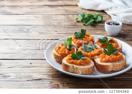 Sandwiches with bread zucchini caviar tomatoes onions. Homemade vegetarian food. Canned stewed vegetable. wooden background copy space Sandwiches with bread zucchini caviar tomatoes onions. Homemade vegetarian food. Canned stewed vegetable. wooden background copy space 127364368