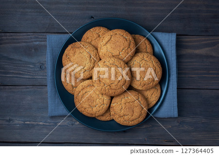 Natural homemade oatmeal cookies on a plate, dark wooden background, copy space. Natural homemade oatmeal cookies on a plate, dark wooden background, copy space. 127364405