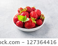 Juicy ripe strawberries in a plate on a concrete background. Sweet healthy dessert, vitamin harvest. copy space. 127364416