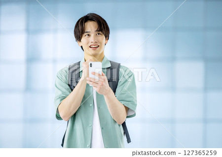 College student with smartphone in office lobby College student with smartphone in office lobby 127365259