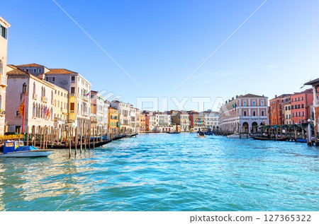 Beautiful view of the Grand Canal with palaces, gondolas and boats in sunny day in Venice, Italy. Beautiful view of the Grand Canal with palaces, gondolas and boats in sunny day in Venice, Italy. 127365322