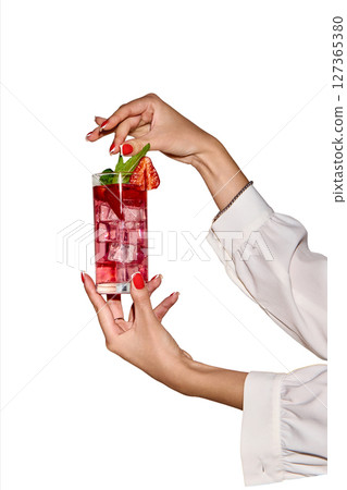 Red refresh. Female hand in blouse holding a strawberry mocktail with mint. Concept of party, celebration. Red refresh. Female hand in blouse holding a strawberry mocktail with mint. Concept of party, celebration. 127365380