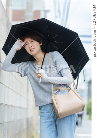 A woman staggering with heat stroke 127365434