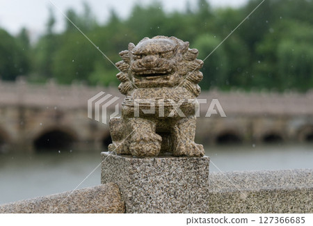 Stone lions on the ancient bridge in the rain Stone lions on the ancient bridge in the rain 127366685