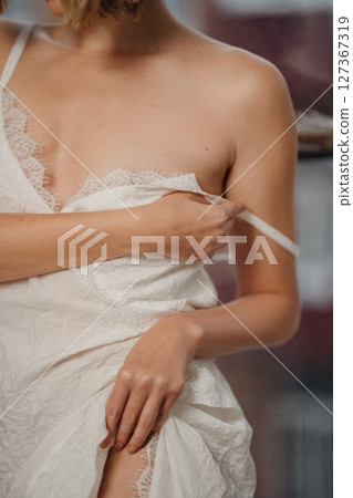 without a face. woman in a white dress with lace on straps without a face. woman in a white dress with lace on straps 127367319
