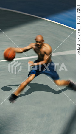 Dynamic motion blur of shirtless basketball player in action. Physical endurance, muscle development. Dynamic motion blur of shirtless basketball player in action. Physical endurance, muscle development. 127367891