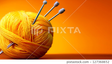 Yellow Ball of Wool With Knitting Needles on Orange Background - Generative Ai 127368652