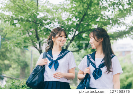 A high school girl in summer clothes commuting to school 127368876