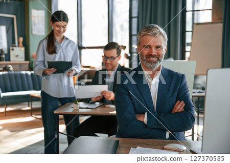 Man is smiling. Group of business people are working in the modern office 127370585