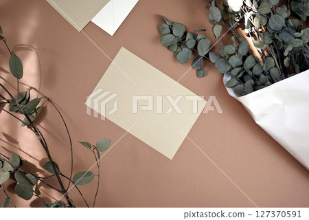 Handmade photo taken natural light and shadow blank card mockup design flat lay floral eucalyptus 127370591