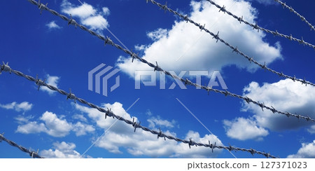 Barbed wire and sky in background - 3D illustration Barbed wire and sky in background - 3D illustration 127371023
