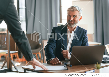 Two men is working on the project. Business people are together in the office 127371356