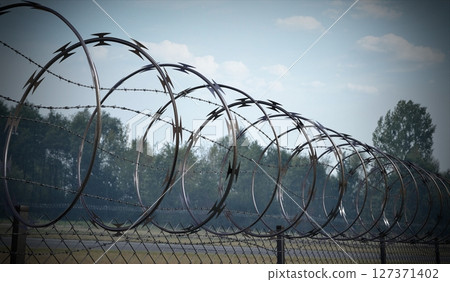 Spiral concertina barbed wire fence - 3d illustration Spiral concertina barbed wire fence - 3d illustration 127371402