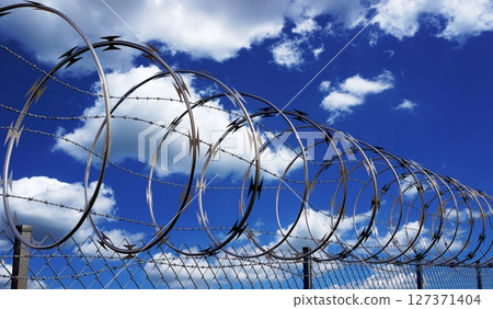 Spiral concertina barbed wire fence - 3d illustration Spiral concertina barbed wire fence - 3d illustration 127371404