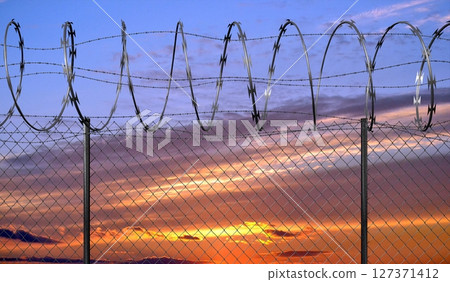 Spiral concertina barbed wire fence - 3d illustration 127371412